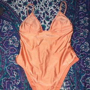 New, unworn one piece orange swimsuit, size M.